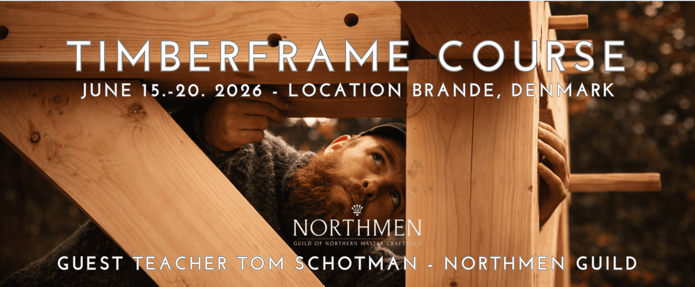 Tom Schotman of Northmen Guild peering through a raised post-and-beam timber frame. Text overlay: Timberframe Course, June 15-20 2026, Location Brande Denmark